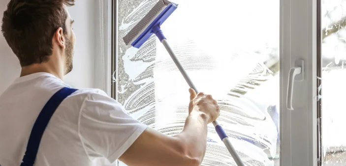 a guy cleaning window